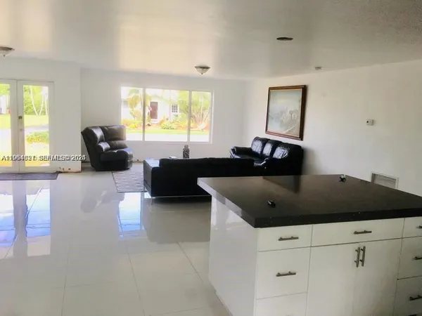 a living room with furniture and a large window