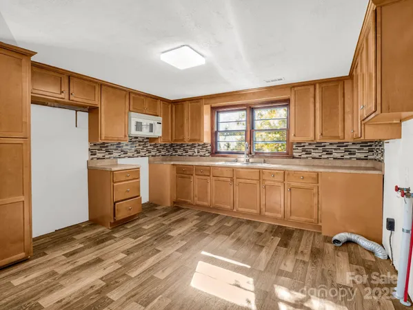 a kitchen with sink refrigerator and cabinets