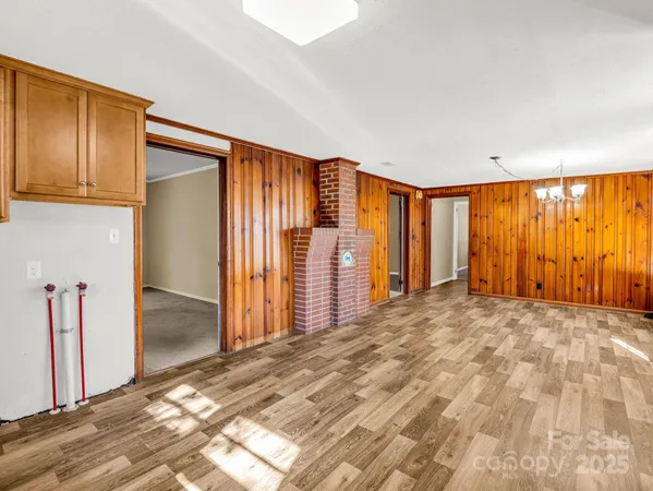 an empty room with windows and ceiling fan