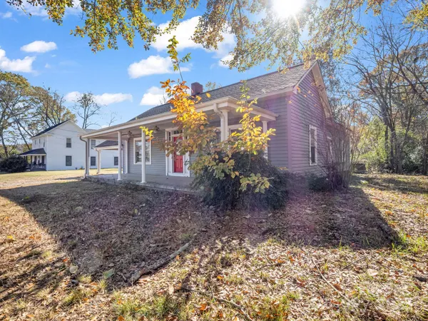 a view of a house with a yard and tree s