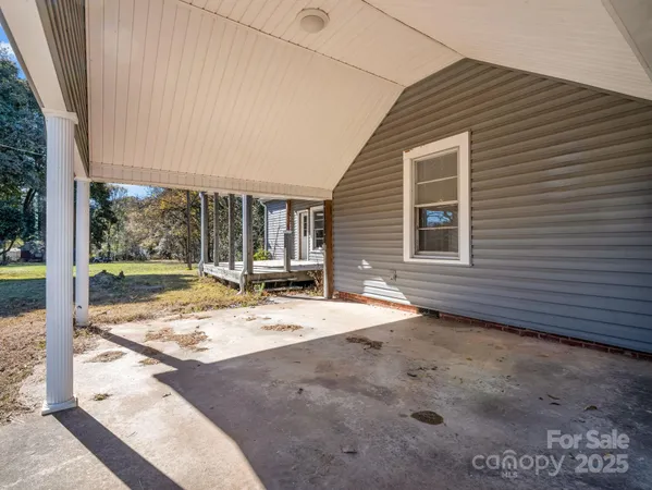 a view of a house with a backyard and floor to ceiling window