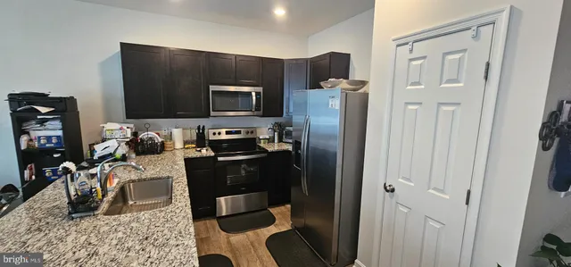 a kitchen with a refrigerator stove and a sink
