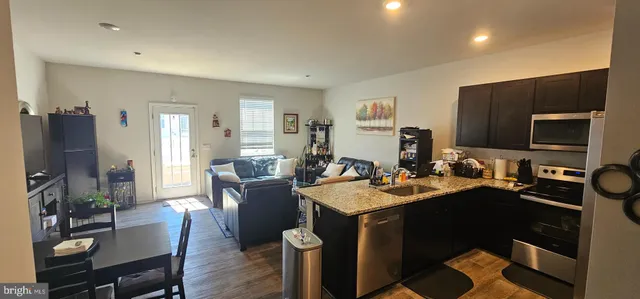 a view of a dining room with furniture and a flat screen tv