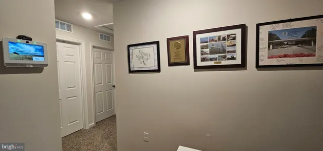 a view of a hallway with paintings on the wall