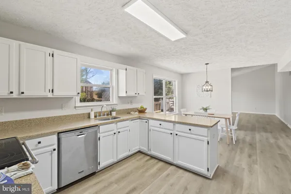 a kitchen with a sink stove and cabinets