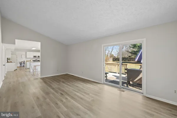 an empty room with wooden floor and a window