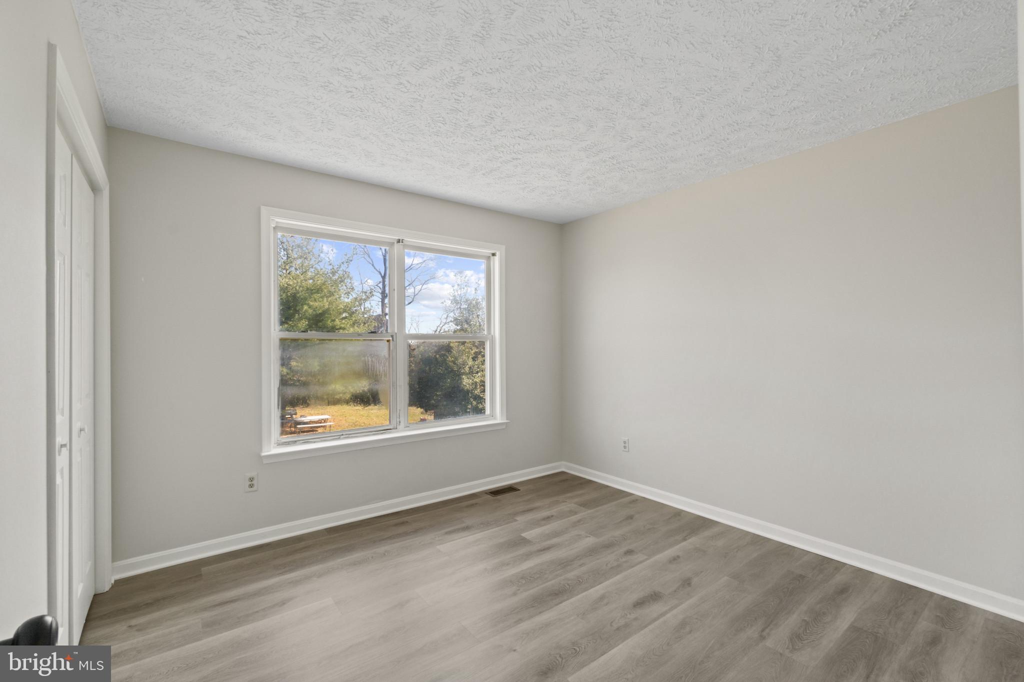 607 Brentwood Road Linthicum Heights, MD 21090 - Photo 18 of 31 an empty room with wooden floor and windows