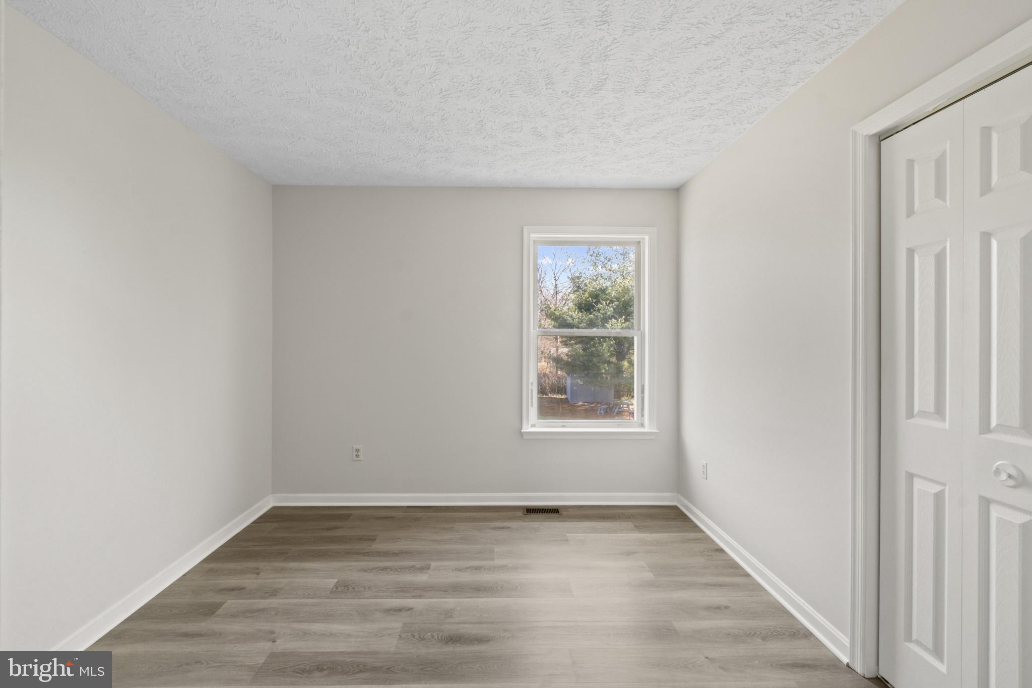 607 Brentwood Road Linthicum Heights, MD 21090 - Photo 19 of 31 an empty room with wooden floor and windows