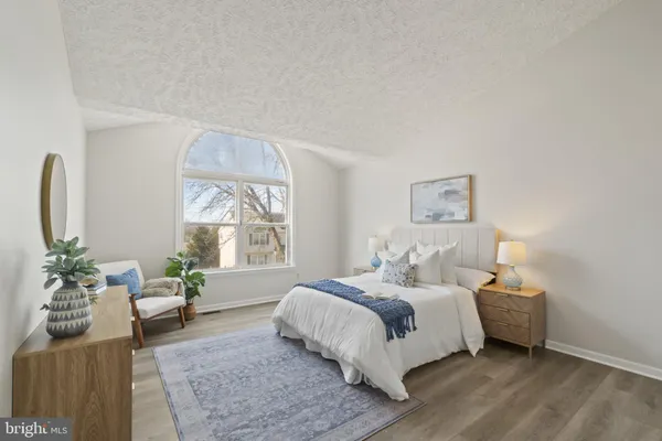 a bedroom with a large bed and a couch
