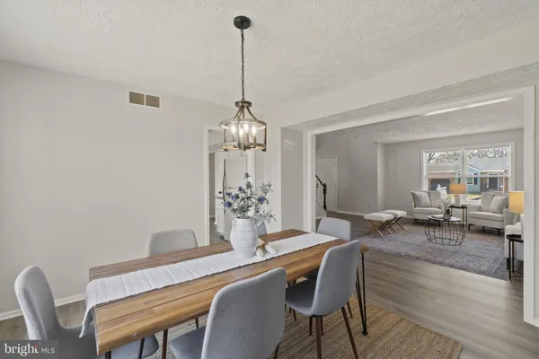 a view of a dining room with furniture wooden floor and chandelier