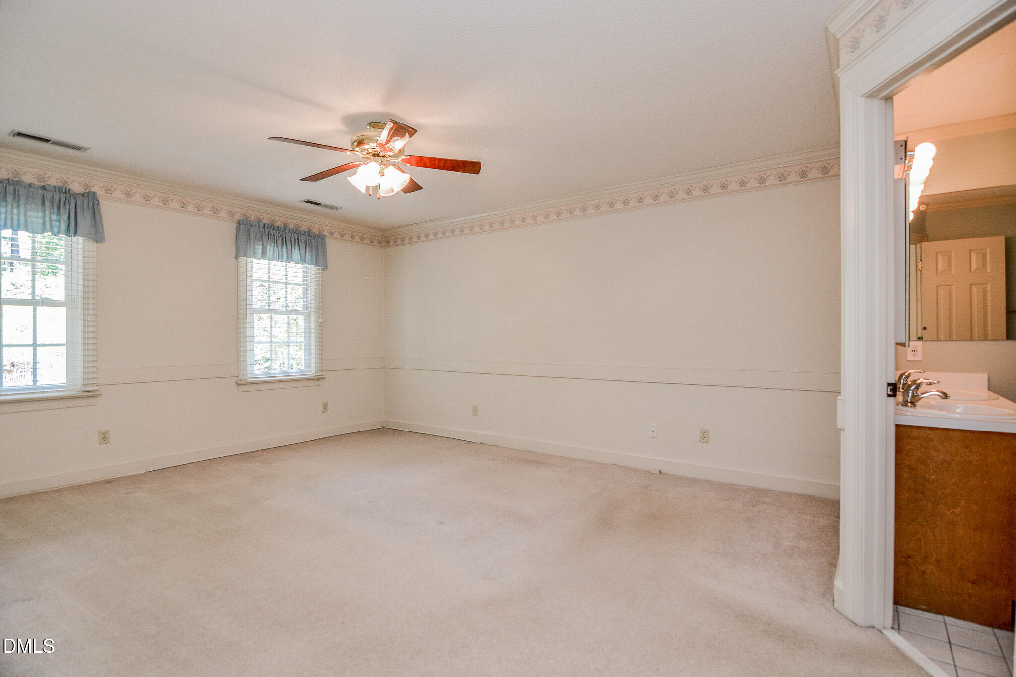 1215 Cambridge Road Northwest Wilson, NC 27896 - Photo 39 of 54 an empty room with chandelier fan and windows