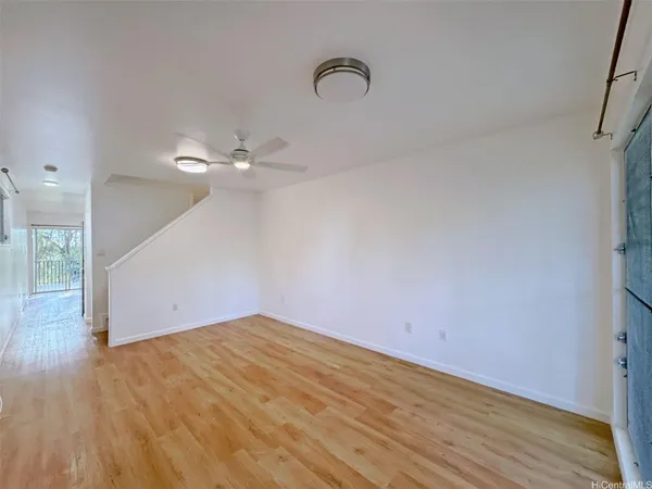 a view of a room with wooden floor and white walls