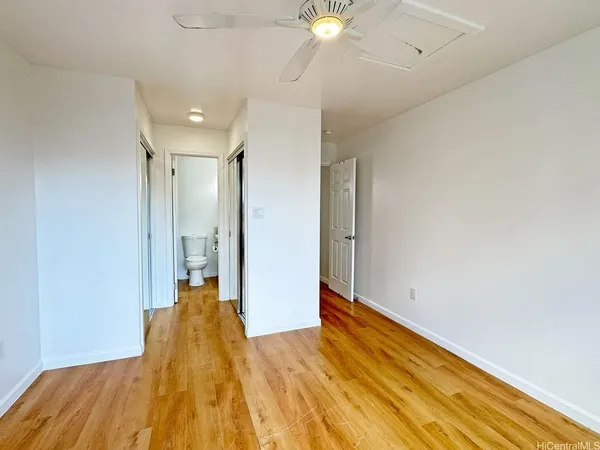 a view of a room with wooden floor