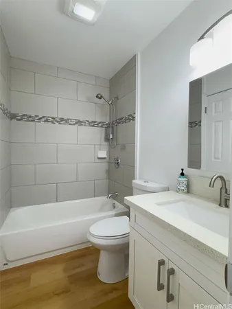 a bathroom with a sink a toilet and bathtub