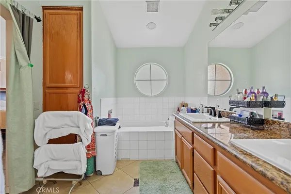 a bathroom with a sink mirror and a bathtub