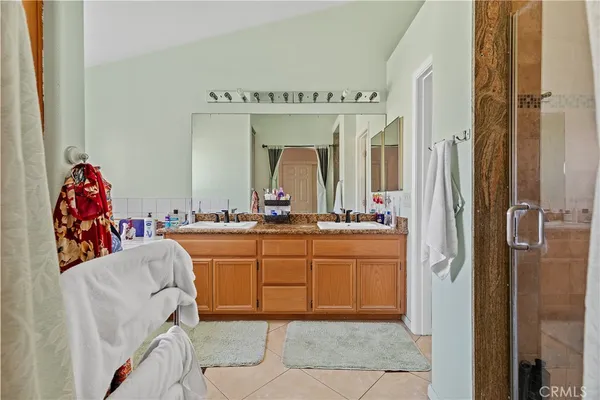 a spacious bathroom with a mirror and shower