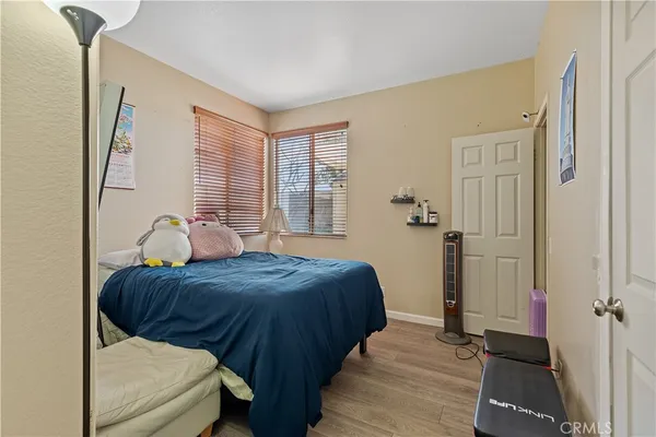 a bedroom with a bed and wooden floor