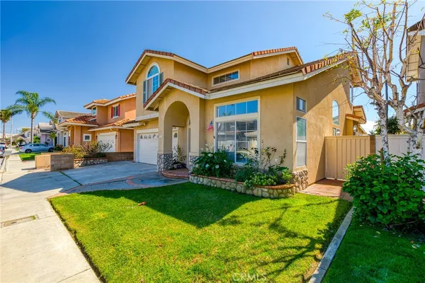 a front view of a house with yard and green space