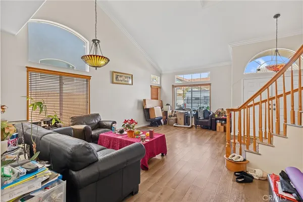 a living room with furniture and a wooden floor