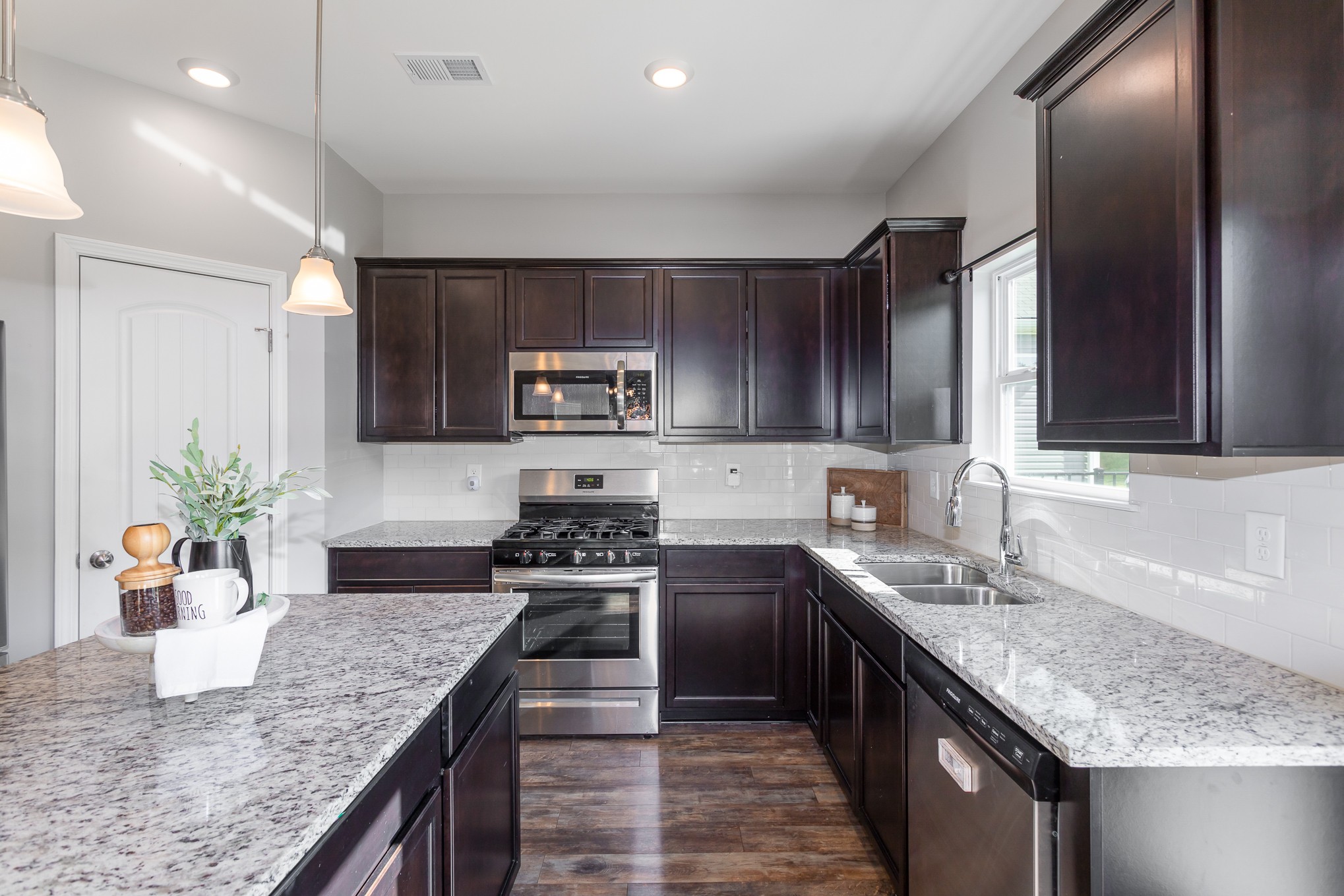 525 Burchell Lane Columbia, TN 38401 - Photo 13 of 35 a kitchen with stainless steel appliances granite countertop sink stove microwave and cabinets