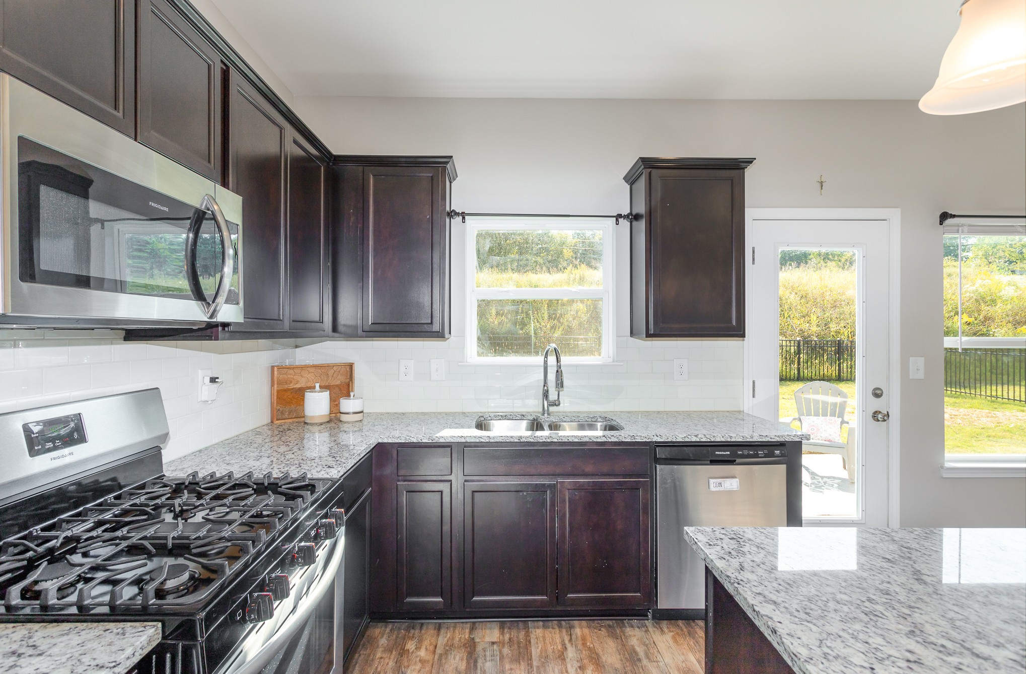 525 Burchell Lane Columbia, TN 38401 - Photo 14 of 35 a kitchen with granite countertop a sink a stove and wooden cabinets