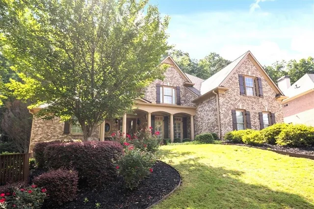 a front view of a house with a garden