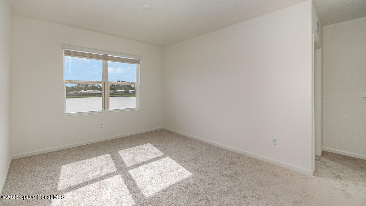 598 Ganley Street Palm Bay, FL 32908 - Photo 11 of 25 an empty room with a window