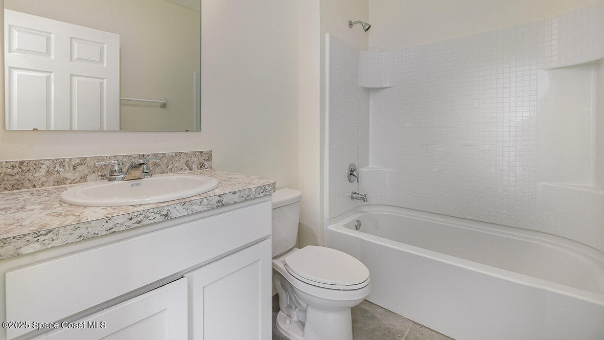 598 Ganley Street Palm Bay, FL 32908 - Photo 14 of 25 a bathroom with a granite countertop sink toilet and shower