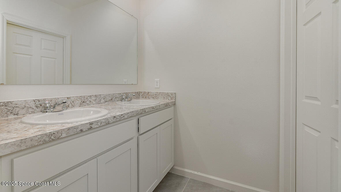 598 Ganley Street Palm Bay, FL 32908 - Photo 17 of 25 a bathroom with a granite countertop sink and vanity