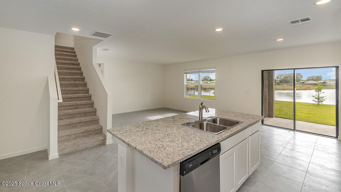 598 Ganley Street Palm Bay, FL 32908 - Photo 6 of 25 a kitchen with granite countertop a sink and a window