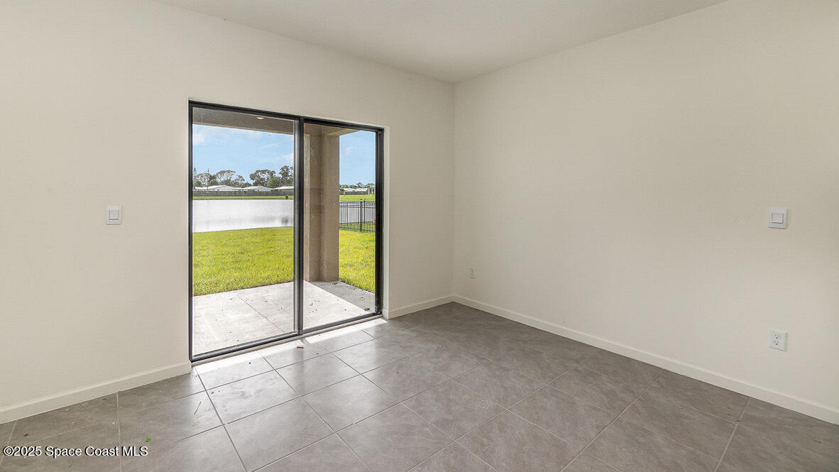598 Ganley Street Palm Bay, FL 32908 - Photo 7 of 25 an empty room with glass door