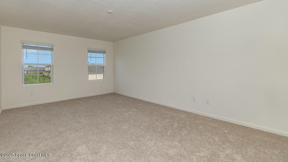 598 Ganley Street Palm Bay, FL 32908 - Photo 8 of 25 an empty room with windows