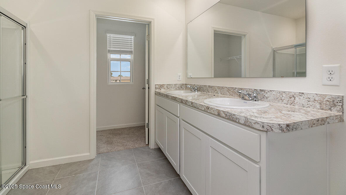 598 Ganley Street Palm Bay, FL 32908 - Photo 10 of 25 a bathroom with a granite countertop sink and a mirror