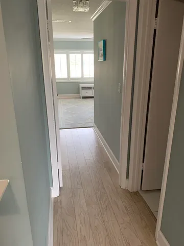 an empty room with wooden floor and a window