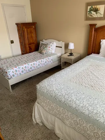 a bedroom with bed and dresser