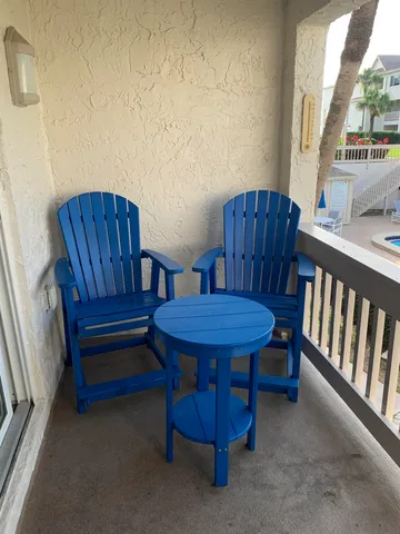 a view of a wooden chairs in patio of the house