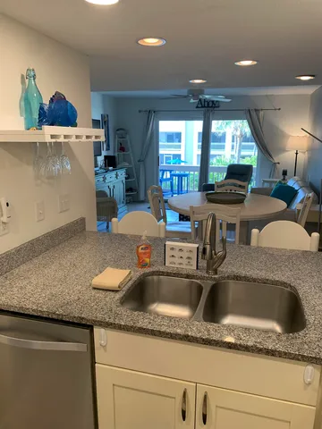 a kitchen with a sink a counter top space and cabinets