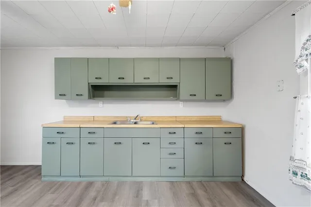 a view of cabinets a wooden floor and a window