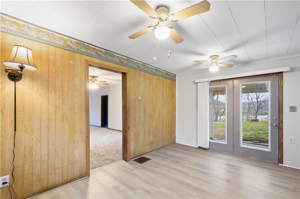 107 Center Street Millsboro, PA 15348 - Photo 15 of 34 a view of a big room with a chandelier fan and windows