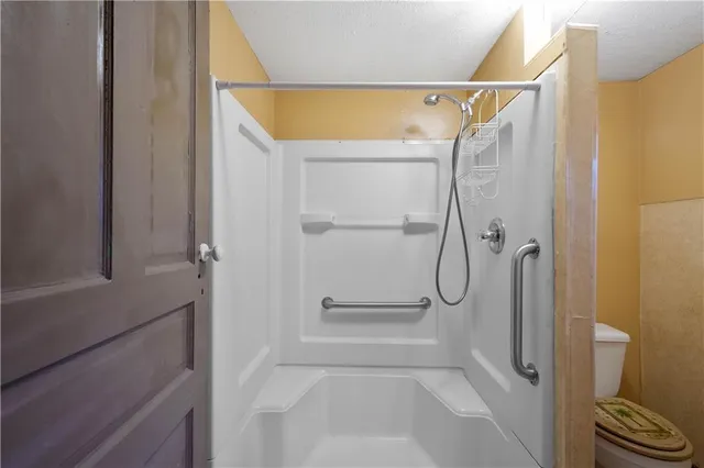 a bathroom with a glass shower door