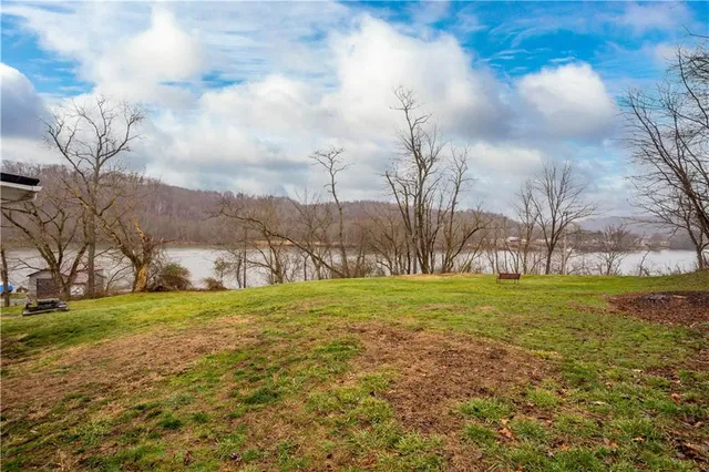 a view of a swimming pool with a yard