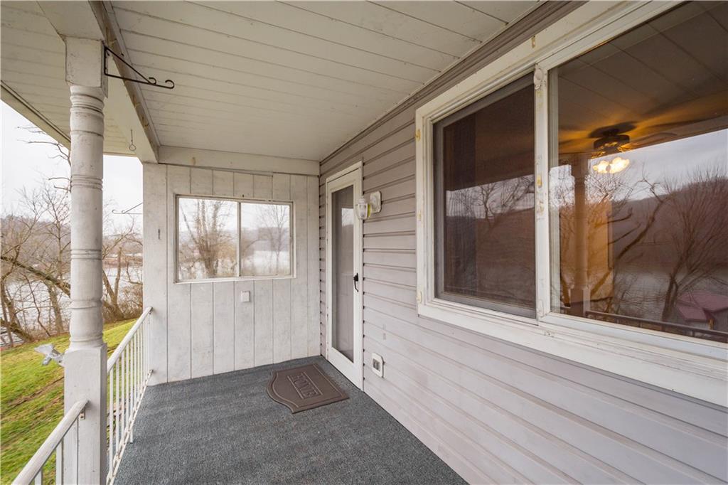 107 Center Street Millsboro, PA 15348 - Photo 5 of 34 a view of a porch with a door and wooden floor
