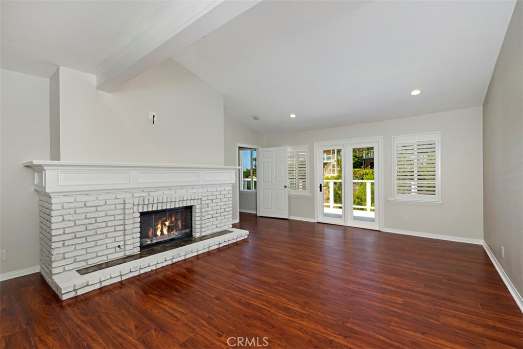33852 Orilla Road Dana Point, CA 92629 - Photo 22 of 49 a view of an empty room with wooden floor fireplace and a window