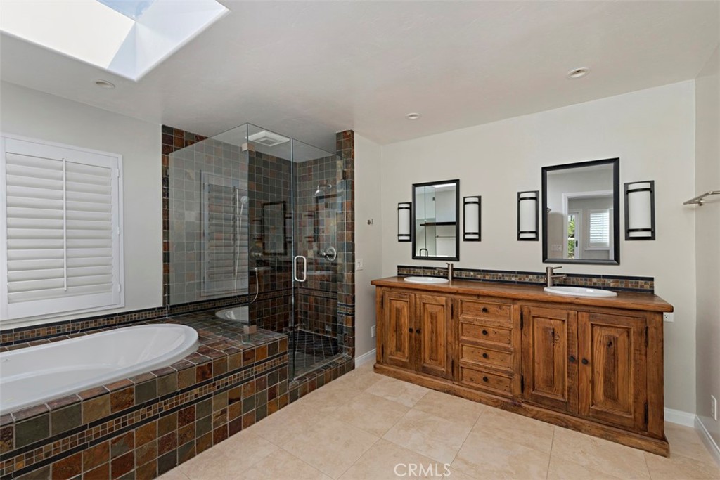 33852 Orilla Road Dana Point, CA 92629 - Photo 23 of 49 a spacious bathroom with a granite countertop sink a mirror and a shower