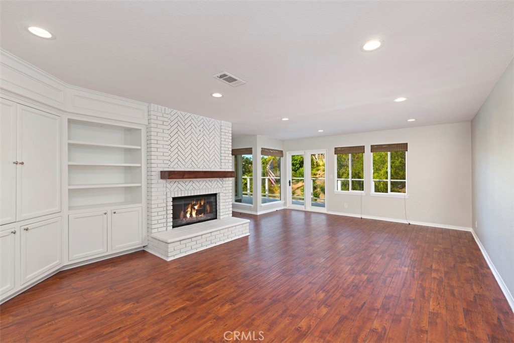 33852 Orilla Road Dana Point, CA 92629 - Photo 6 of 49 a view of an empty room with wooden floor fireplace and a window