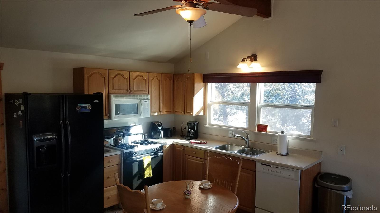 67 Hold Up Street Bailey, CO 80421 - Photo 16 of 25 a kitchen with a sink appliances and cabinets