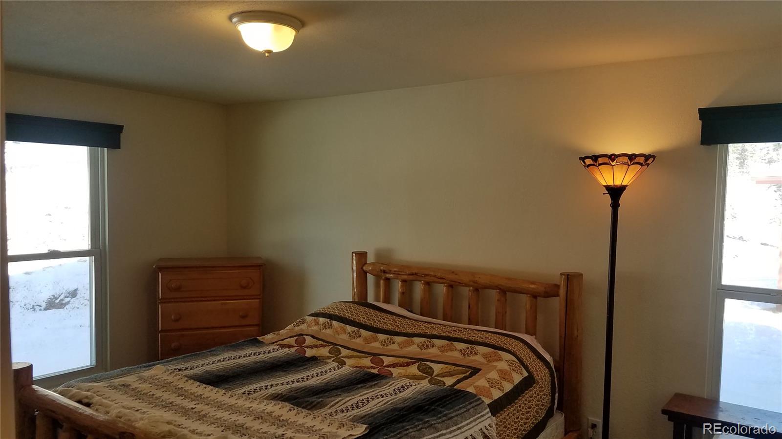 67 Hold Up Street Bailey, CO 80421 - Photo 22 of 25 a bedroom with a bed and a window