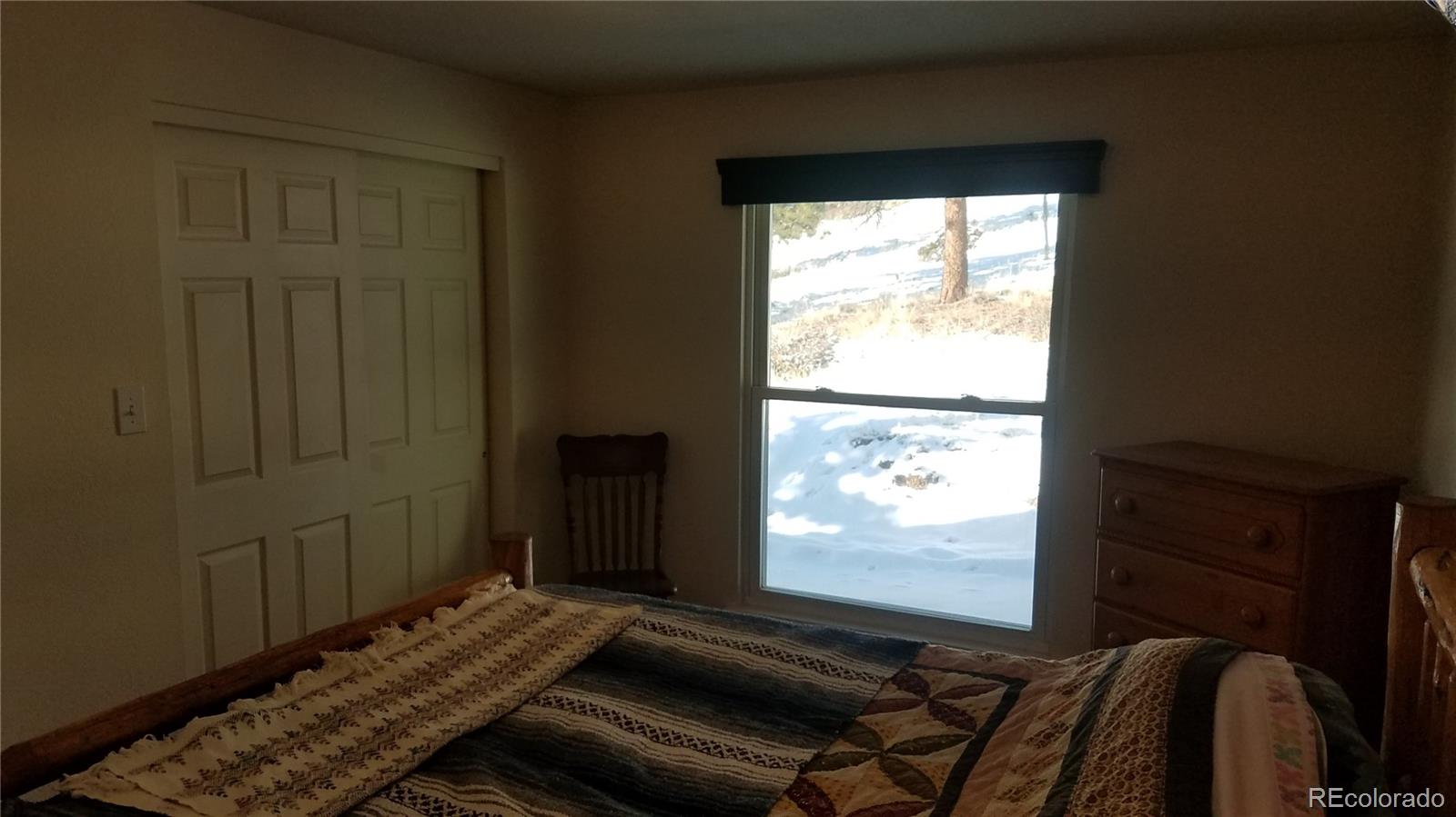 67 Hold Up Street Bailey, CO 80421 - Photo 23 of 25 a room with wooden floor and windows