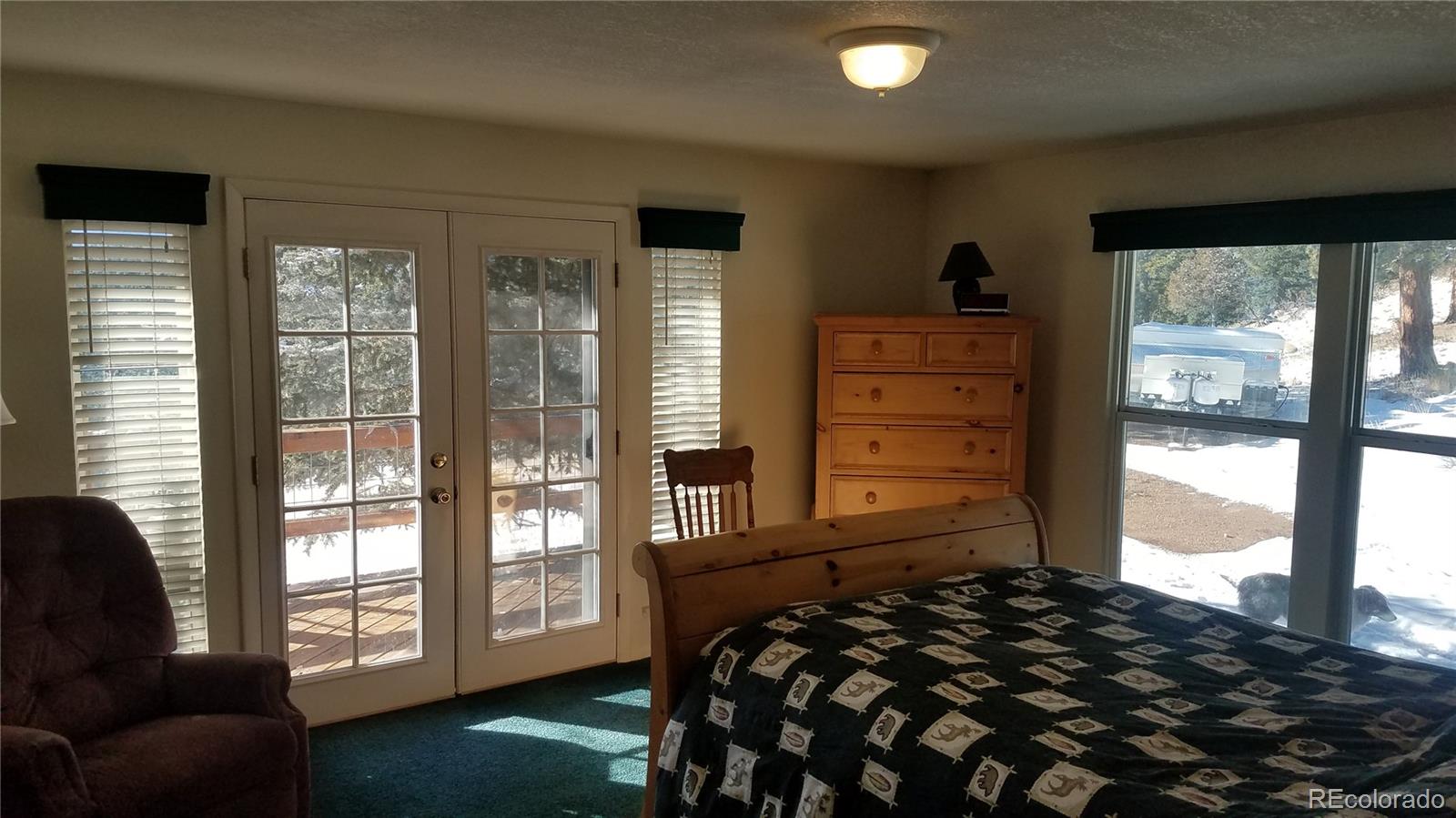 67 Hold Up Street Bailey, CO 80421 - Photo 24 of 25 a bedroom with a bed and large window