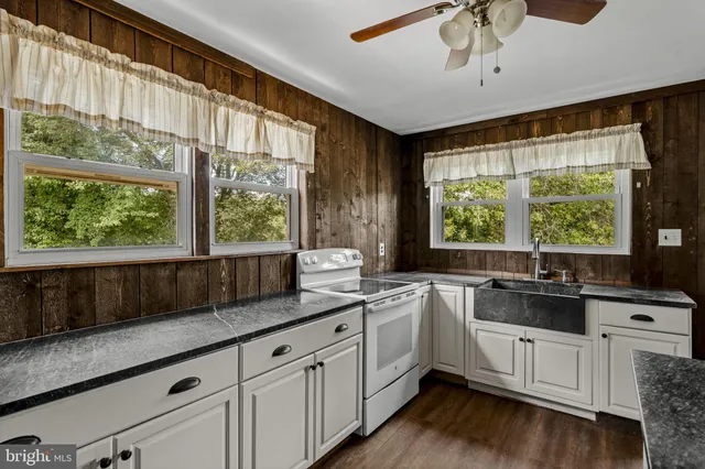 a kitchen with a sink window and cabinets